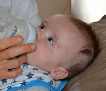 baby drinking on a bottle